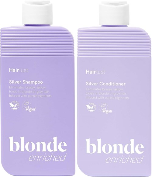 To lyse lilla flasker med Hairlust Silver Sjampo og Balsam med hvite lokk, merket med produktdetaljer og vegansymbol.