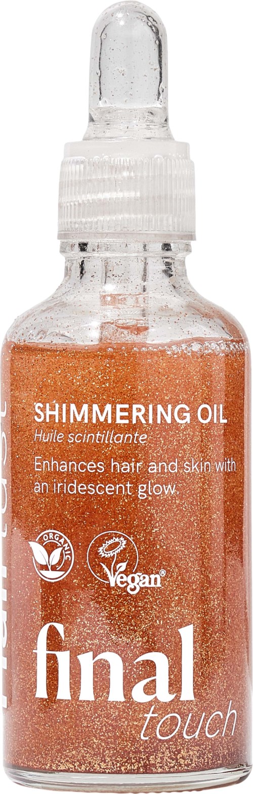 Shimmering oil in a glass bottle with a dropper, labeled Final Touch, enhances hair and skin with an iridescent glow.