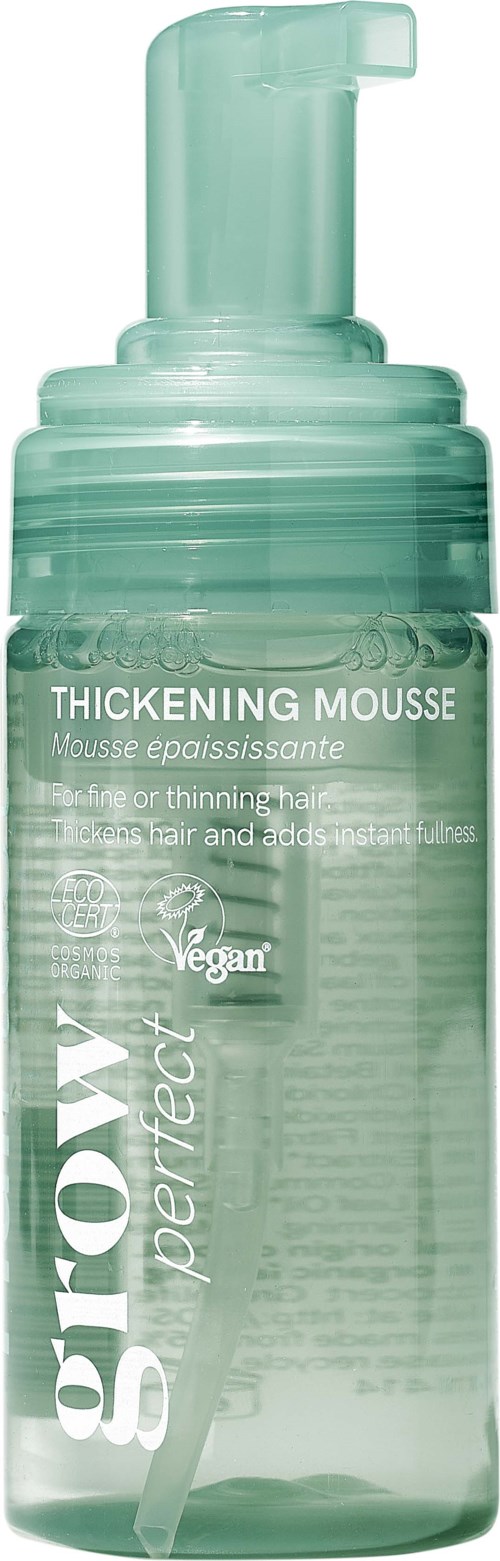 En tydlig pumpflaska med volymgivande mousse, mintgrön etikett och vitt tryck, med fokus på veganska ingredienser.