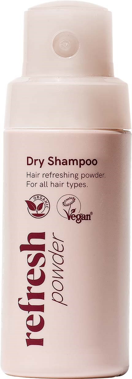 A light pink bottle of Dry Shampoo with a pump top, labeled fresh powder for all hair types, vegan, and hair refreshing.