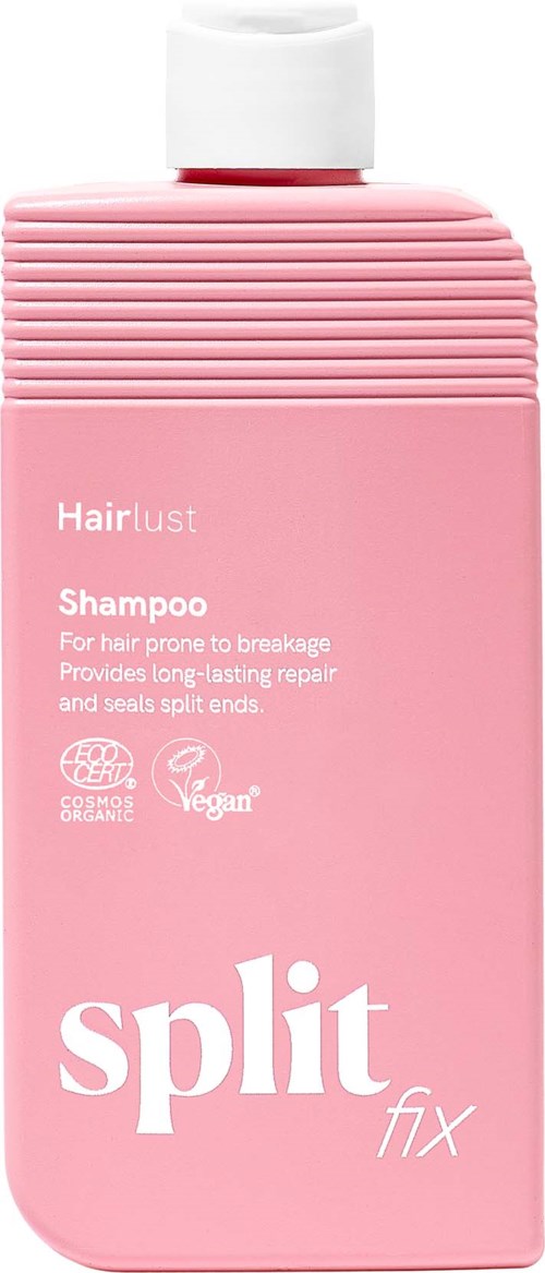 Lys rosa sjampoflaske med hvit kapsel og ribbet topp. Tekst på flasken sier Hairlust Sjampo for hårbrudd og helbredelse.