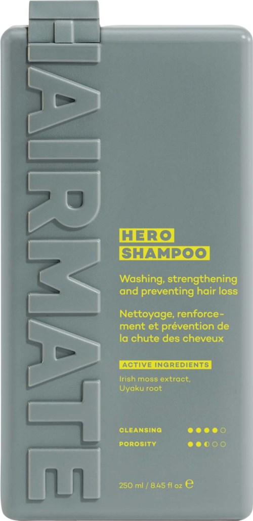 Een grijze shampoo fles met grote verticale tekst 'AIR MASKE' en gele accenten voor 'HERO SHAMPOO'.