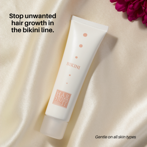 A white tube with pink dots and the words BIKINI and HAIR STOP. Text says it reduces unwanted hair growth and is gentle.