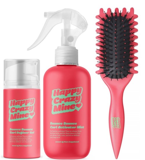 Ein Set aus Haarstylingprodukten und einer Bürste in Pink mit schwarzen Borsten.