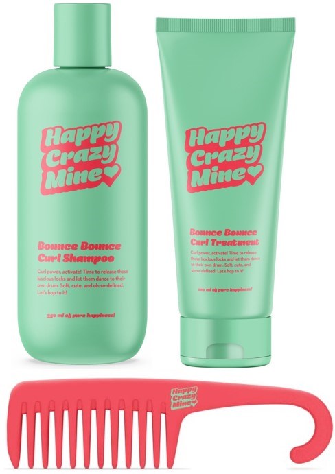 Ein grüner Shampoo und eine grüne Behandlungstube mit rosa Text, und ein rosa Breitkamm.