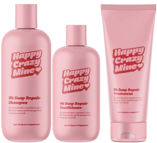 Roze flessen en een tube met de tekst Happy Crazy Mine, shampoo, conditioner en behandeling voor haarherstel.