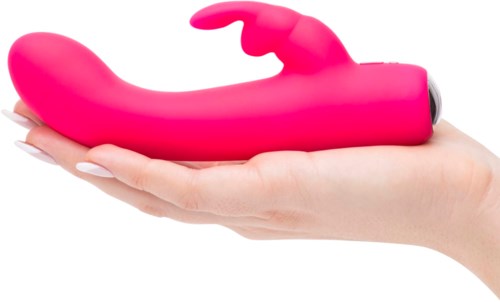 A pink curved vibrator with a small rotating tip, held in a person's hand.