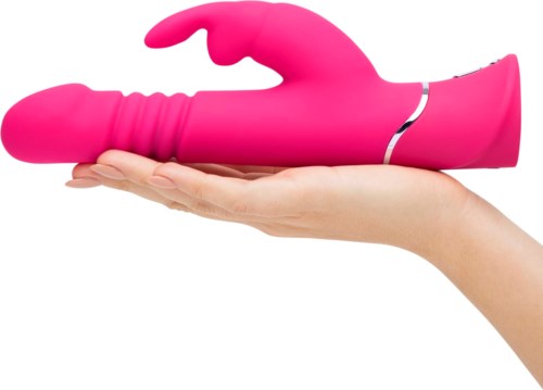 A pink, curved, remote-controlled toy on a person's hand. It is shaped like a hand with fingers. Compact and smooth.