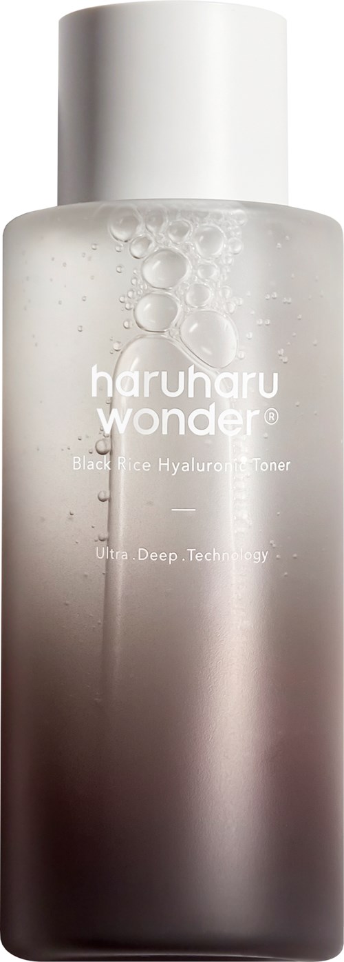 Een heldere fles met een witte dop en een verloop van wit naar donker, bevat een toner gemarkeerd als huidverzorgingsproduct.