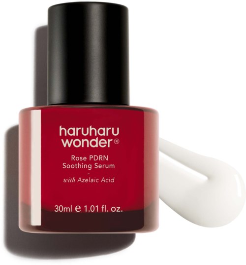 A red bottle of Haruharu Wonder Rose PDRN soothing serum with a drop of white serum next to it.