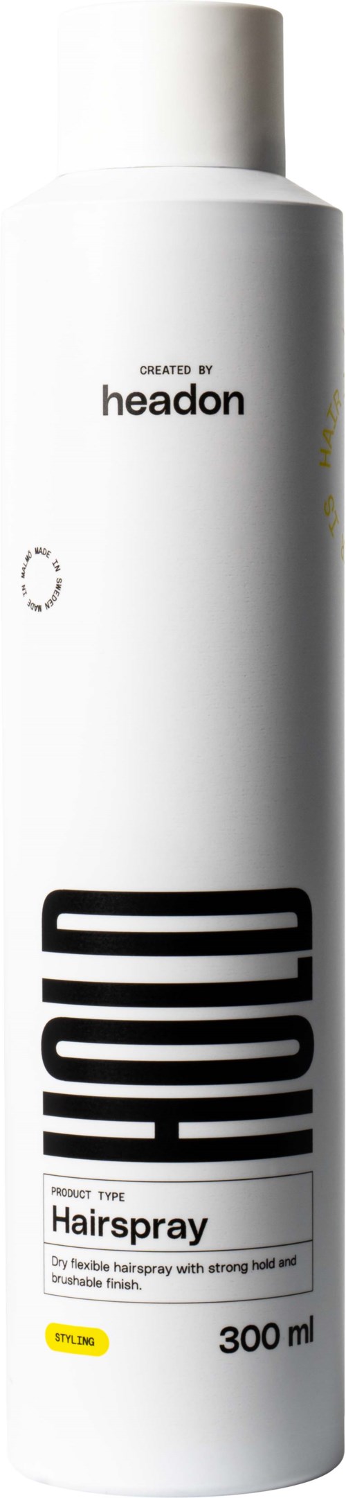 En lång vit burk med hårspray, märkt "HOULE" och "Hairspray," med lock på toppen.