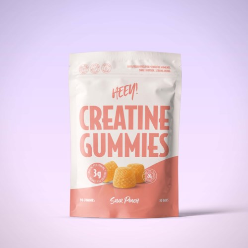 Förpackning med persikafärgade kreatin-gummies med rosa och vit design, visar två gummies och fet stiltext.
