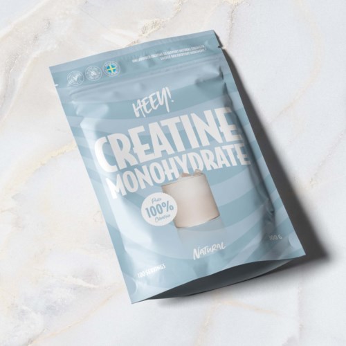 A light blue package labeled 'Creatine Monohydrate' with a clear scoop and natural ingredients.