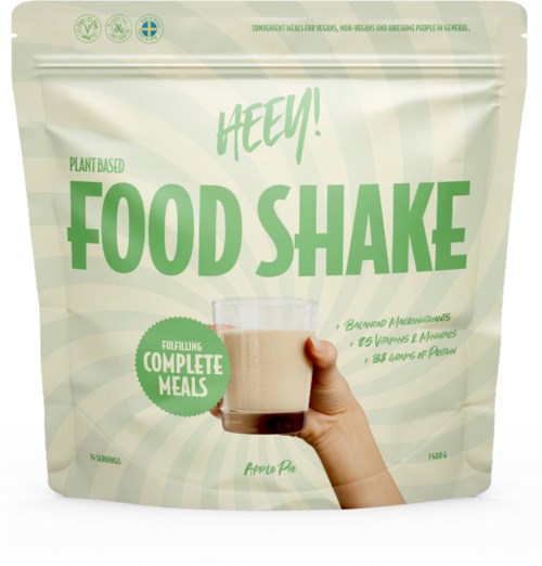 A green and white package labeled 'HECY! Food Shake,' with a hand holding a glass of the shake, stating it is plant-based.