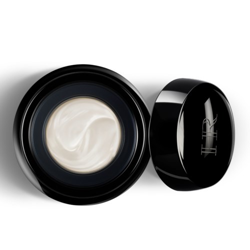 Een ronde zwarte container met witte crème erin, deksel ligt ernaast.
