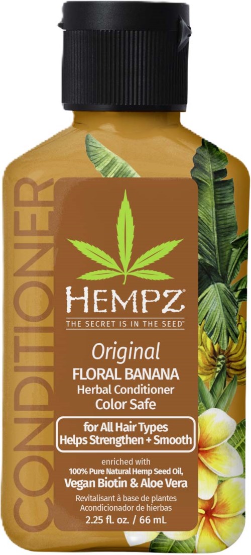 A small bottle of hemp herbal conditioner with floral banana scent, green leaves design, and black cap.