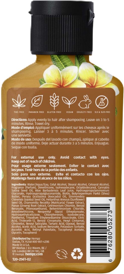 Bottle with a yellow liquid, tropical flower, and leaves, indicating a hair or body product, possibly shampoo or oil.