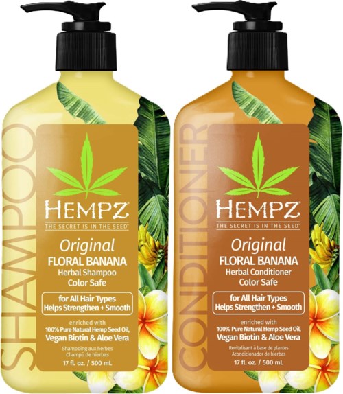 Two bottles of HEMPZ shampoo and conditioner with floral banana scent, green leaves, and aloe vera, for all hair types.