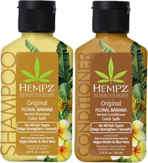 Two bottles of herbal shampoo and conditioner with banana and aloe vera, promoting hair health and color protection.