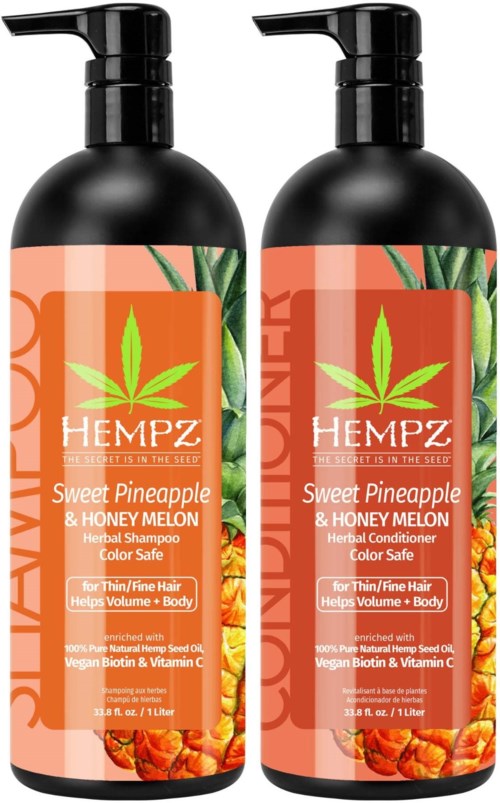 Two black bottles with orange labels featuring green leaves, titled 'HEMPZ', containing herbal shampoo for hair and body.