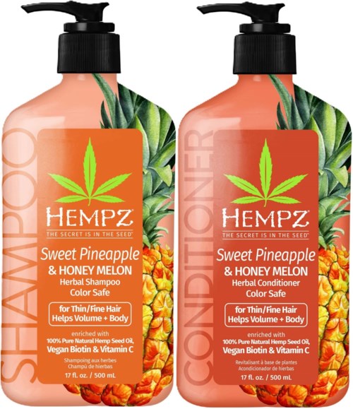 Two bottles of pineapple and honey melon herbal shampoo and conditioner with green leaves design. Safe for color and thin hair.
