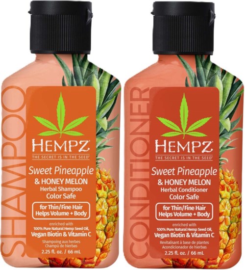 Two bottles of hair care products labeled for thin hair, with pineapple and honey melon extracts, featuring green leaves and orange labels.
