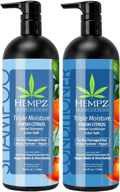 Two black bottles of hemp shampoo and conditioner with blue labels, green leaf logo, orange citrus images, and blue text.
