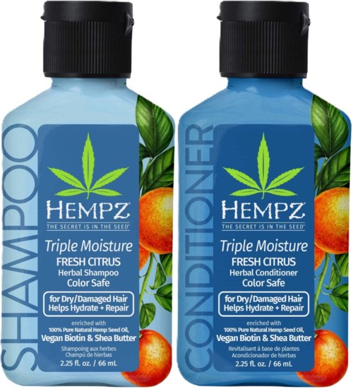 Two bottles of hemp-based hair care products, one shampoo, one conditioner, with bright citrus and green leaf labels.