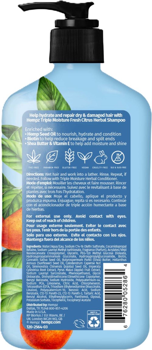 Blue shampoo bottle with green leaves and orange fruits, label details about hair care and ingredients.