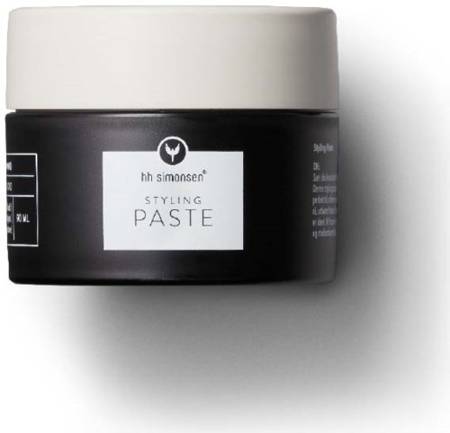 Een zwarte pot met een witte deksel en label, gelabeld "Styling Paste" voor haarstyling.
