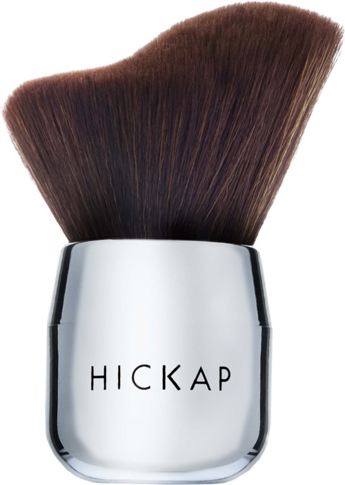 A makeup brush with brown bristles and a silver handle that says "HICKAP."