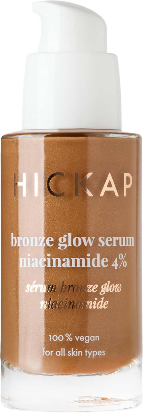 A bottle of bronze glow serum with a white pump, labeled as vegan, for all skin types, containing niacinamide 4%.