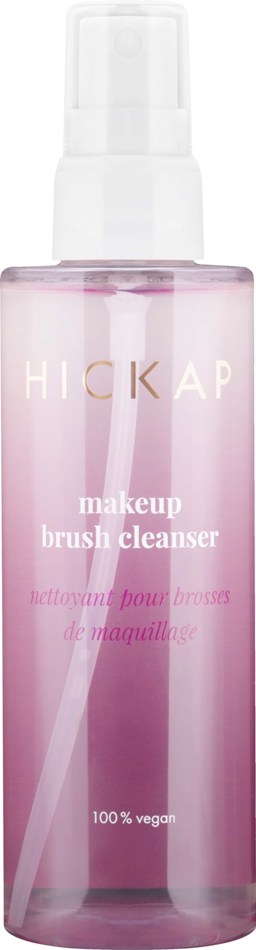A pink transparent bottle with a spray cap labeled 'HICKAP makeup brush cleanser' and '100% vegan.'