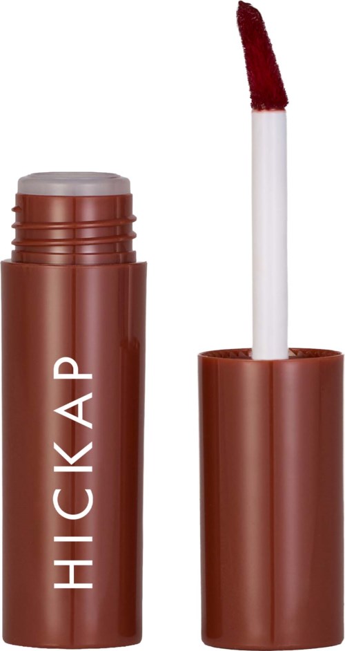 A lip gloss or liquid lipstick container with a brush applicator, labeled HICKA, in brown color.