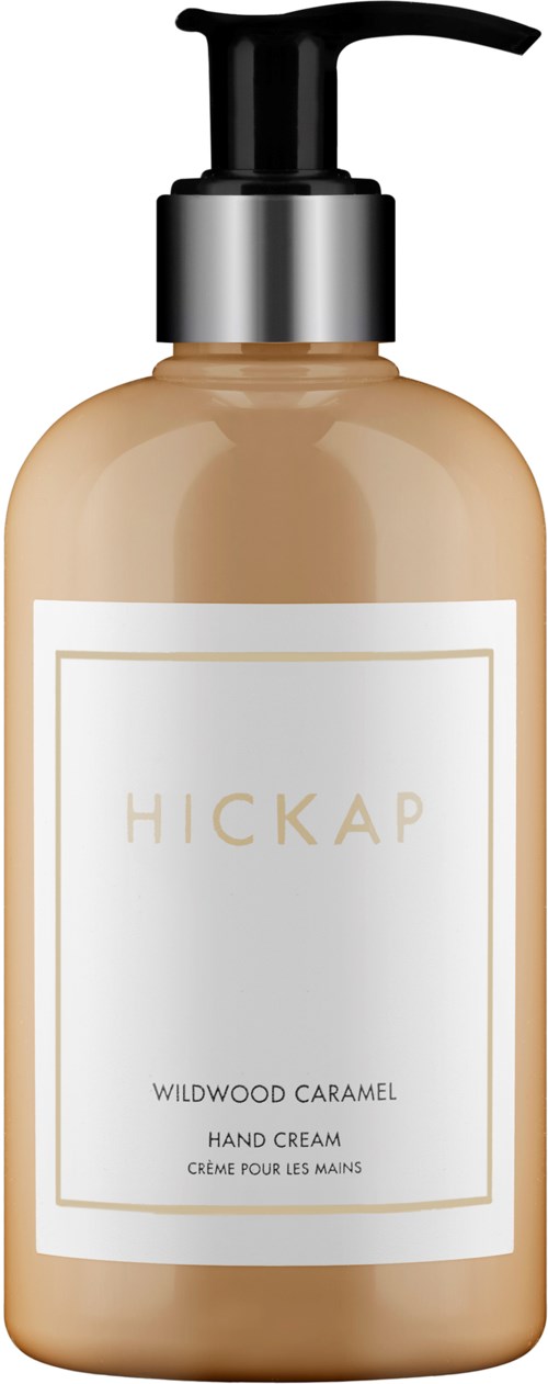 A lotion bottle labeled Hickap Wildwood Caramel Hand Cream with a pump top.