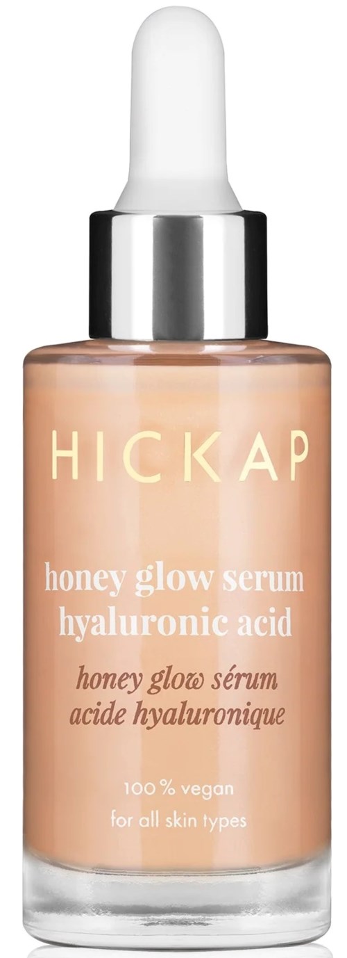 A skincare serum bottle with a white dropper cap, labeled 'HICKAP honey glow serum hyaluronic acid,' vegan and for all skin types.