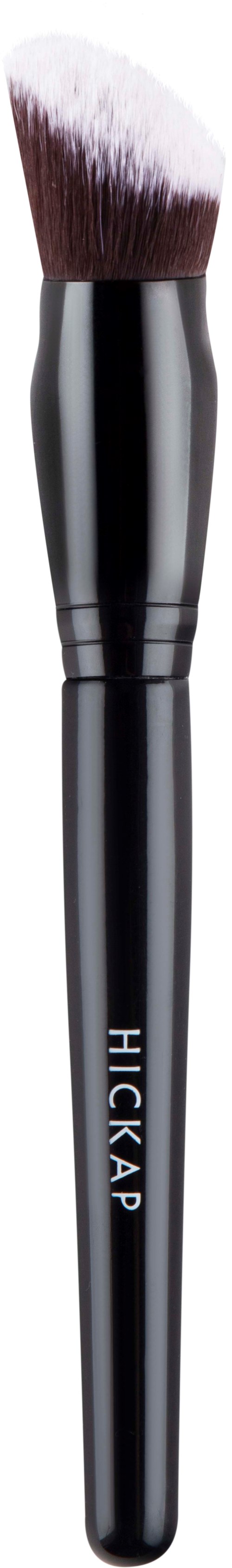 A makeup brush with black handle and white bristles, labeled 'HICKAP', against a black background.