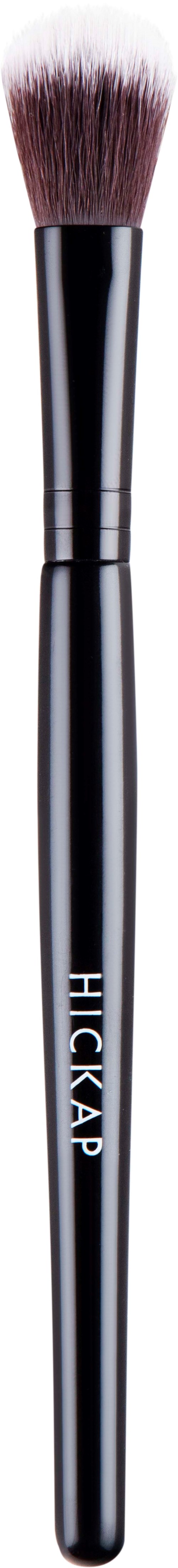 A makeup brush with a black handle and white, fluffy bristles.