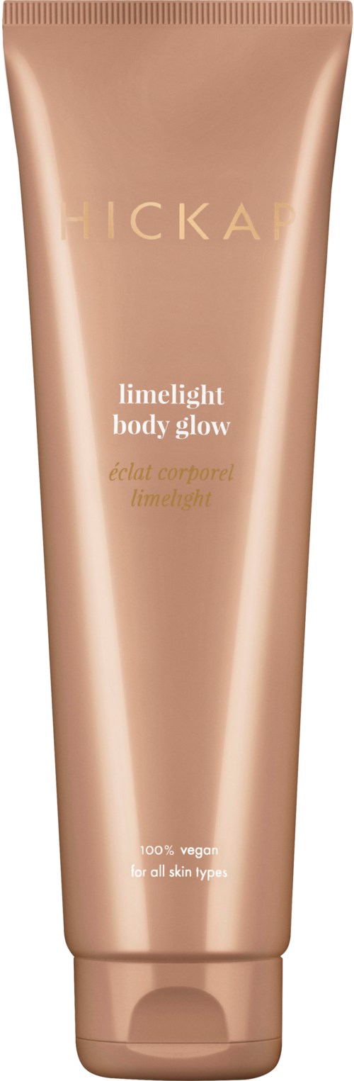 A peach-colored tube of FICKA Limelight Body Glow with gold and white text, standing upright.