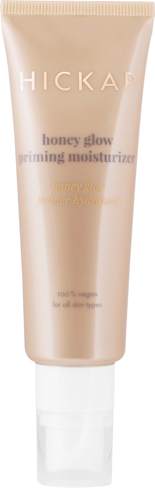 A tube of Hickap honey glow primer moisturizer. It is light pink with gold and white text.