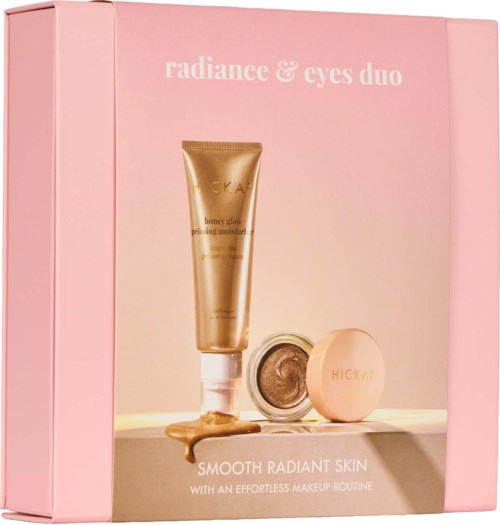 Rosa box med hudvårdsprodukter, inklusive en tub, en burk och ett kompakt, märkt för strålande hud och makeup-rutin.