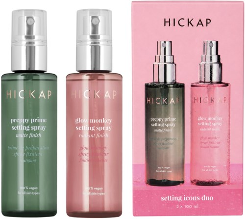 Two spray bottles and a pink box, labeled Hickap, contain setting sprays for skin. The bottles are green and pink.