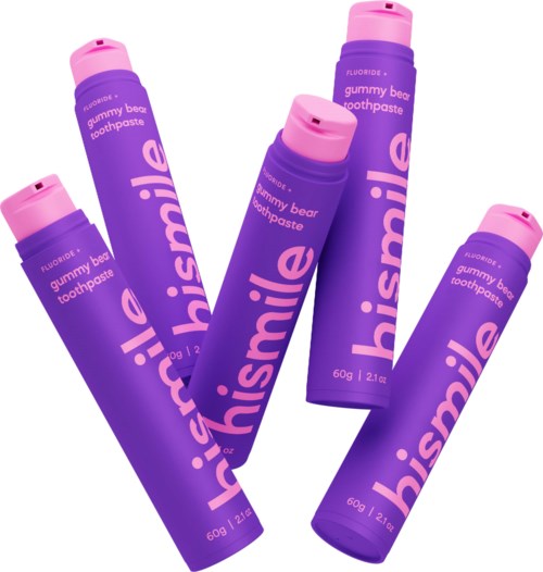 Four purple tubes of gummy bear flavored toothpaste with pink caps, arranged diagonally.