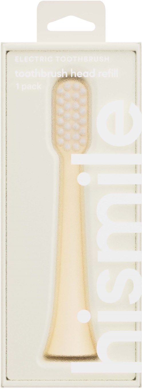 A beige toothbrush inside a clear box with white text on the packaging.