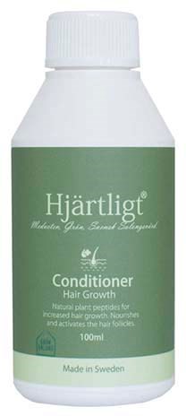 A white bottle with green label for hair growth conditioner, made in Sweden, held against a white background.
