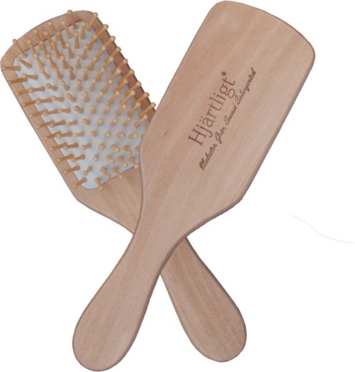 Two wooden hairbrushes with wide, flat surfaces and bristle sides, crossing each other. One has the brand name 'Hjärtligt' engraved.