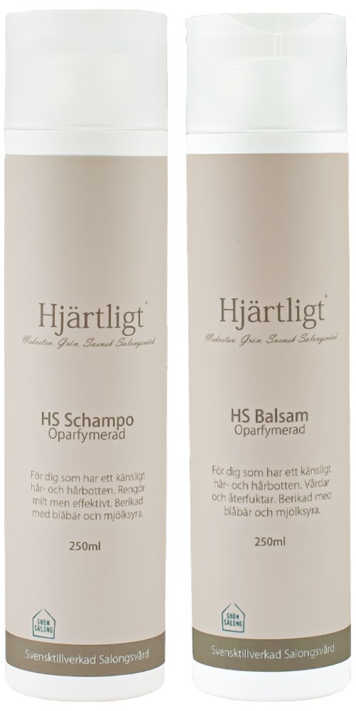 Two white bottles labeled 'Hjärtligt' contain shampoo and conditioner, each 250ml, for caring hair with blueberries and milk.