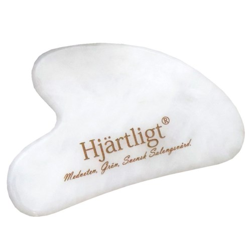 A white massage stone with the word 'Hjärtligt' and some text underneath, used for relaxation or therapy.