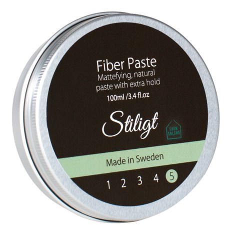 A round container with a black and green label, indicating it is fiber paste made in Sweden, with five levels of hold.