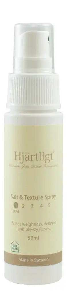 A white spray bottle labeled Hjärtligt salt and texture spray, 50ml, made in Sweden, helps with hair styling.